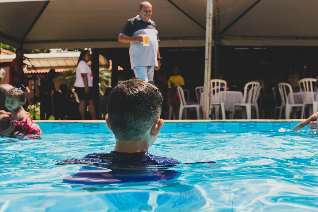 Brazilian man speaking confidently in front of a small group