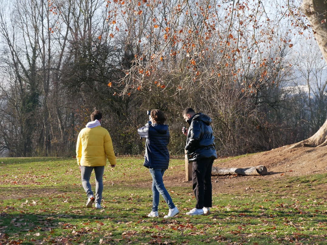Small group walking and talking outdoors in a park