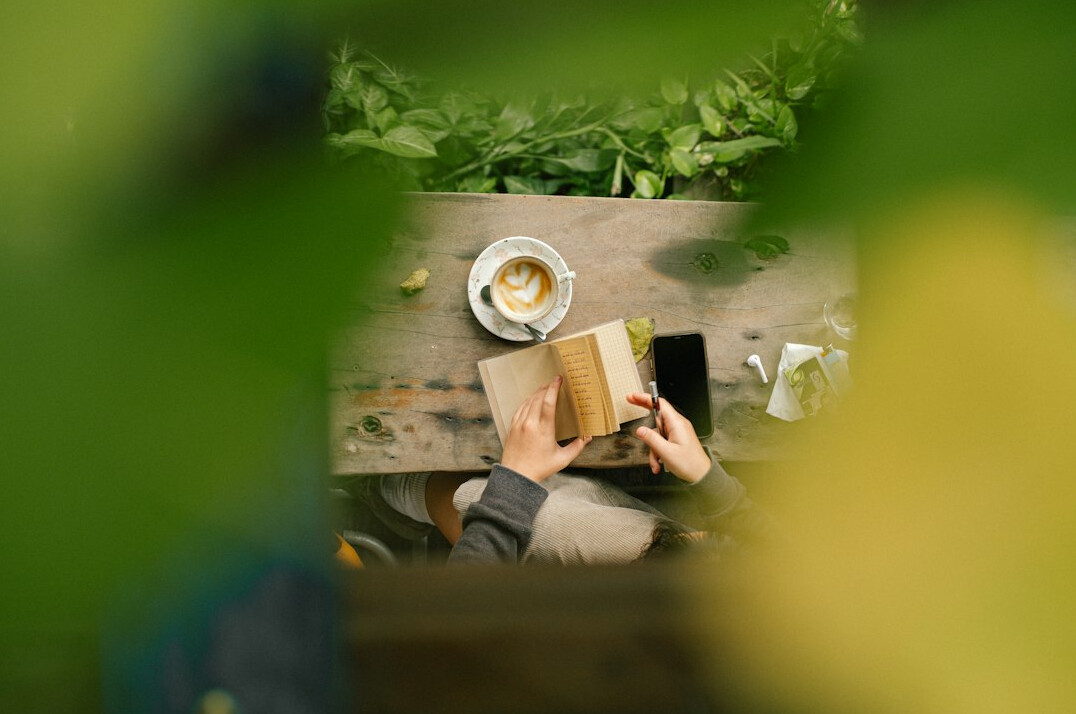 person journaling outdoors