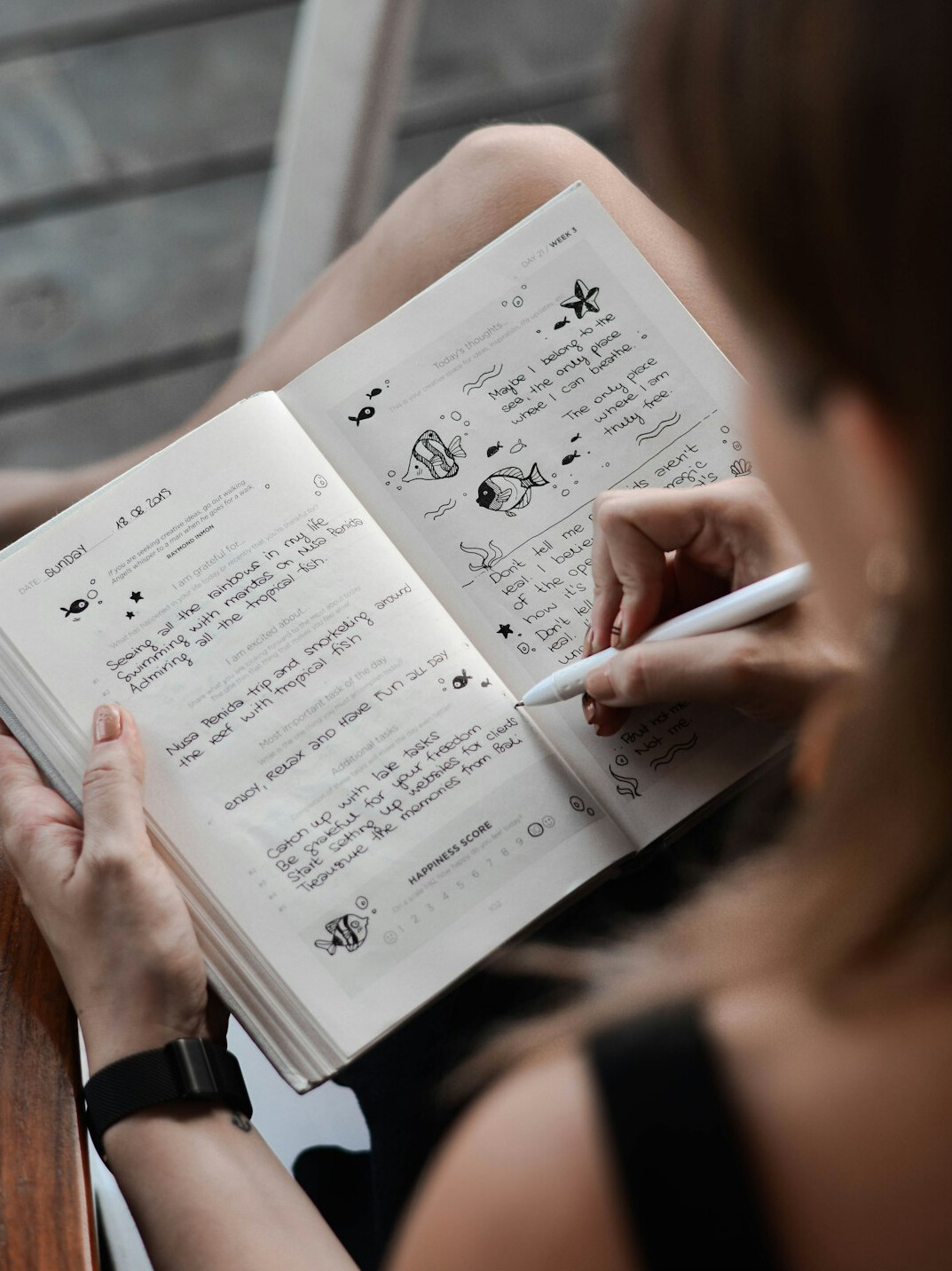 person writing in journal