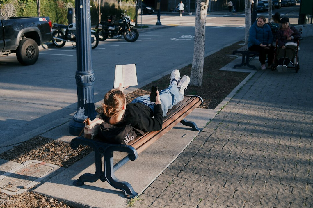 person reading book outdoors